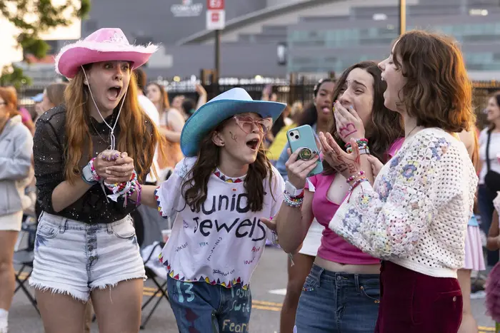 Shayna Weachter, from left, Cecelia Zschunke, Riley O'Brien and Rayana Weachter scream when Taylor Swift's set begins, as they listen from the parking lot outside of Lincoln Financial Field in Philadelphia May 13.